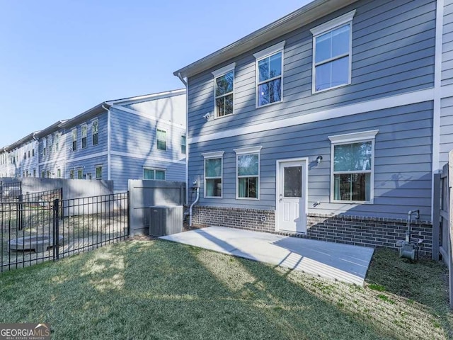 back of house with a patio area, a yard, fence, and central AC