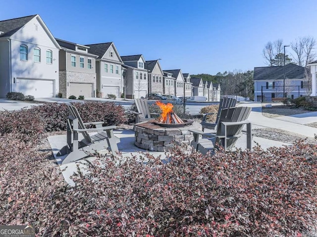 view of patio featuring a residential view and an outdoor fire pit