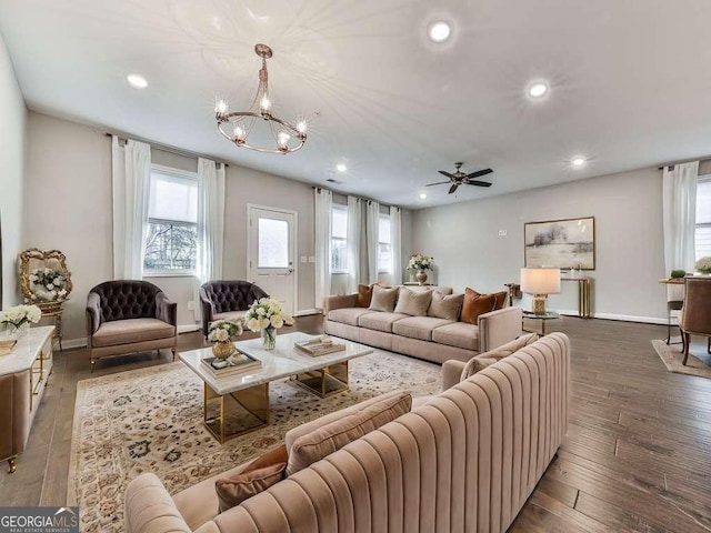 living area featuring recessed lighting, baseboards, ceiling fan with notable chandelier, and hardwood / wood-style flooring