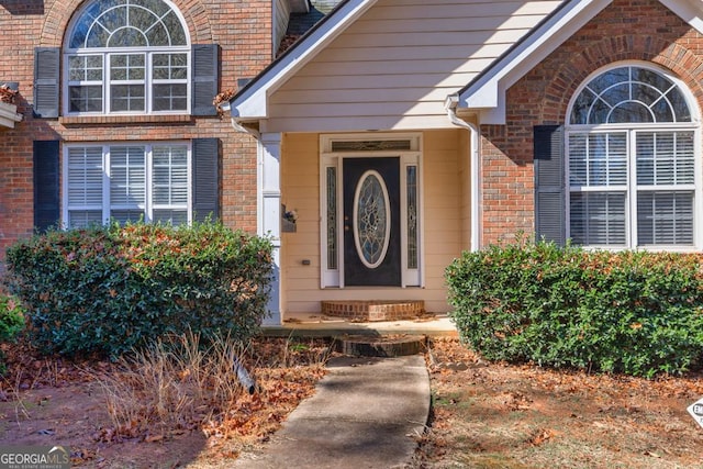 entrance to property with brick siding