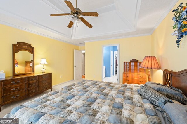 carpeted bedroom with crown molding, a ceiling fan, and a tray ceiling