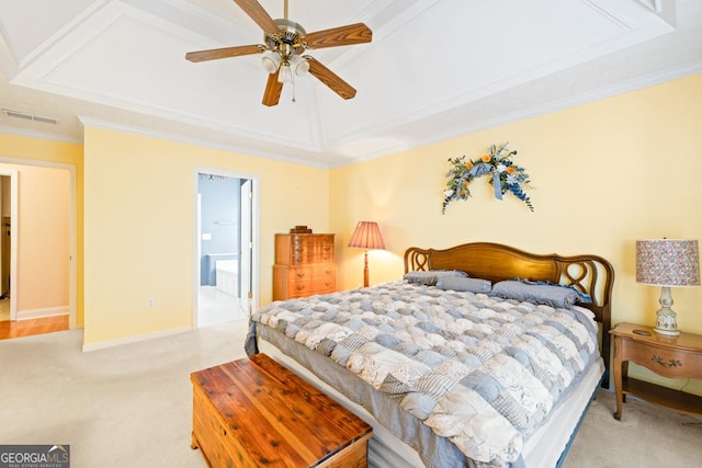 bedroom featuring visible vents, light carpet, a tray ceiling, crown molding, and baseboards