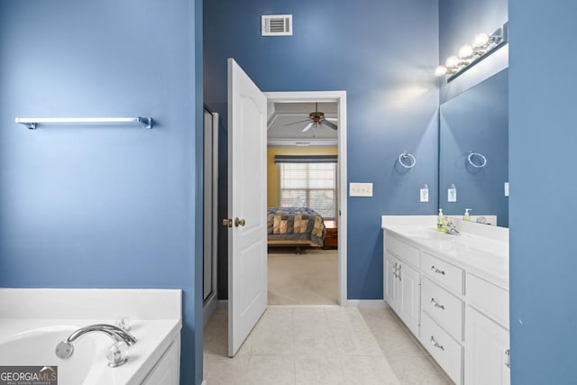 ensuite bathroom with tile patterned floors, visible vents, connected bathroom, a bath, and vanity