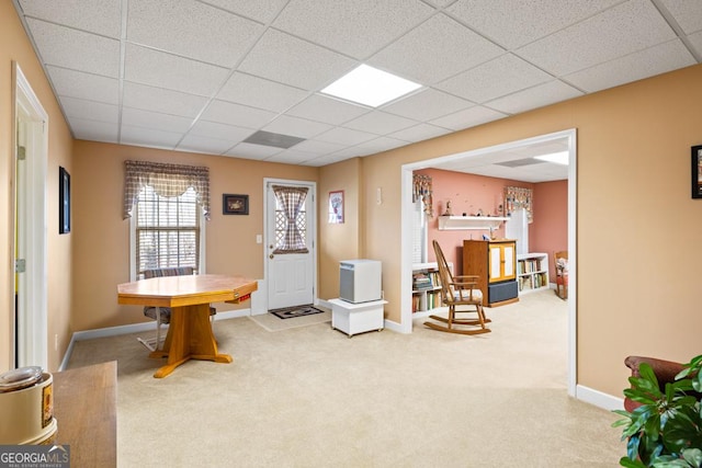 entryway featuring a paneled ceiling, baseboards, and carpet floors