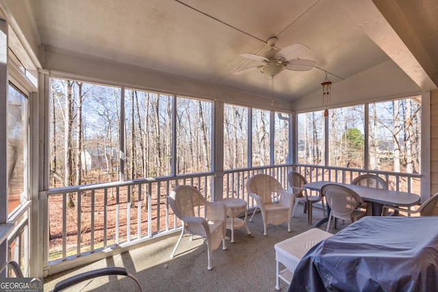 sunroom with a ceiling fan and vaulted ceiling