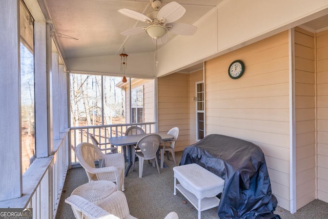 sunroom / solarium featuring a wealth of natural light, ceiling fan, and vaulted ceiling