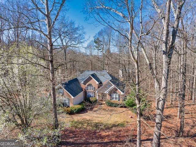 view of front facade with a forest view