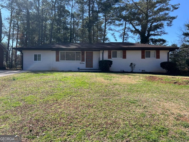 single story home featuring crawl space, a front yard, and brick siding