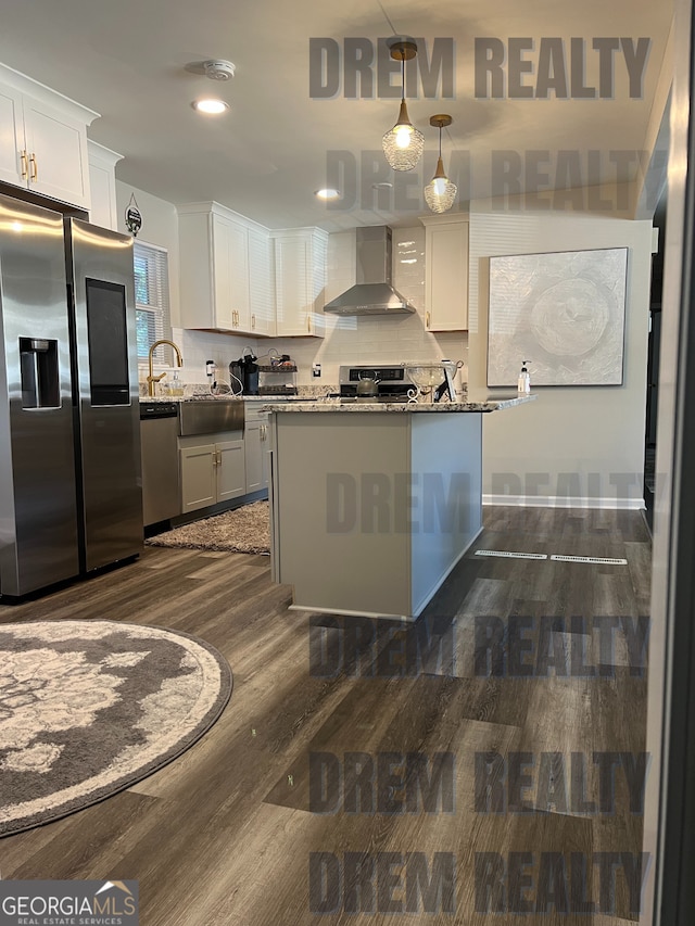 4025 Gretna Dr, Decatur, GA 30035 - kitchen featuring appliances with stainless steel finishes, dark wood-style flooring, wall chimney range hood, and white cabinets