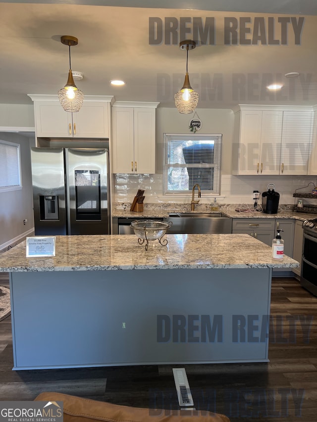 4025 Gretna Dr, Decatur, GA 30035 - kitchen with tasteful backsplash, a sink, white cabinetry, and stainless steel appliances