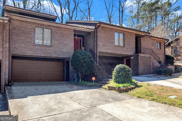 5545 Circlestone Ln, Stone Mountain, GA 30083 - view of front of house with concrete driveway, stairway, an attached garage, and brick siding