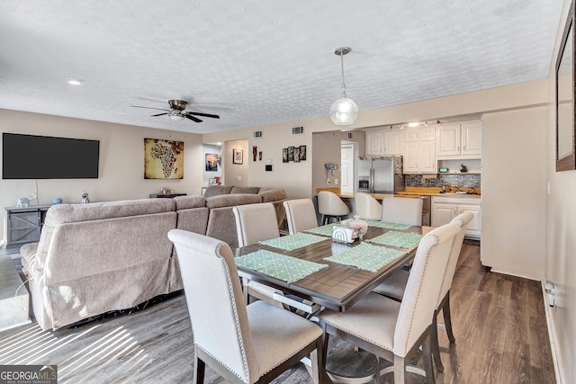 5545 Circlestone Ln, Stone Mountain, GA 30083 - dining space featuring visible vents, dark wood-type flooring, a ceiling fan, and a textured ceiling