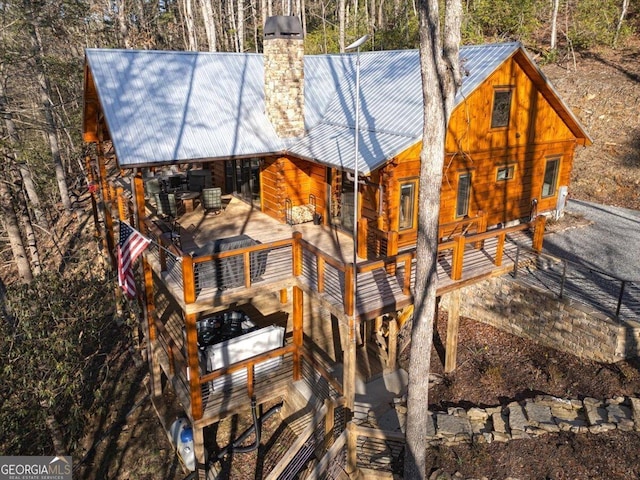 view of front of home with metal roof and a chimney