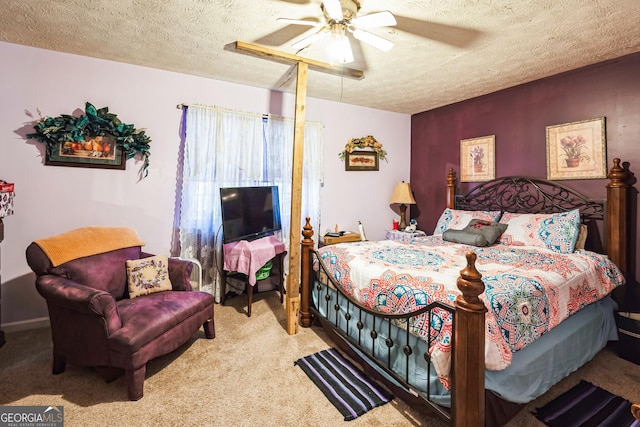 bedroom featuring carpet flooring, a ceiling fan, and a textured ceiling