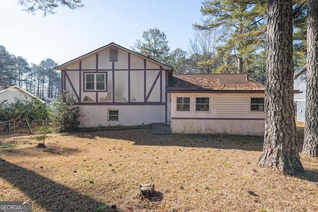 back of property featuring fence and stucco siding