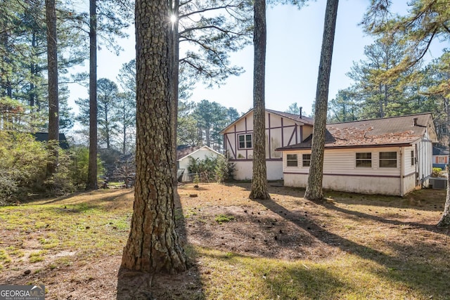 back of property featuring a shingled roof