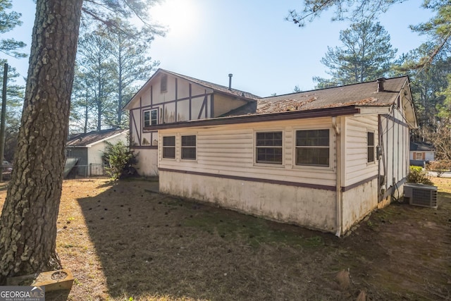 view of side of home with central AC