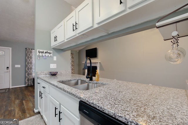 kitchen featuring white cabinetry, light stone countertops, dark wood-style flooring, and a sink