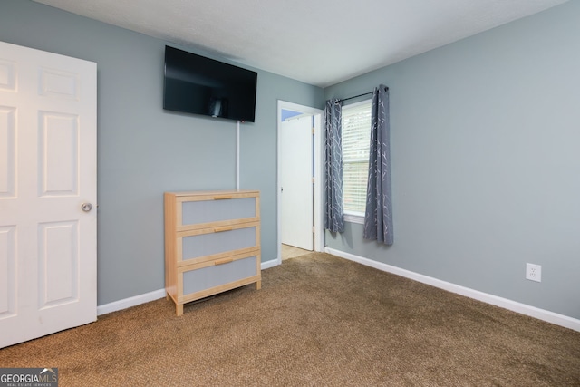 unfurnished bedroom with baseboards and carpet floors