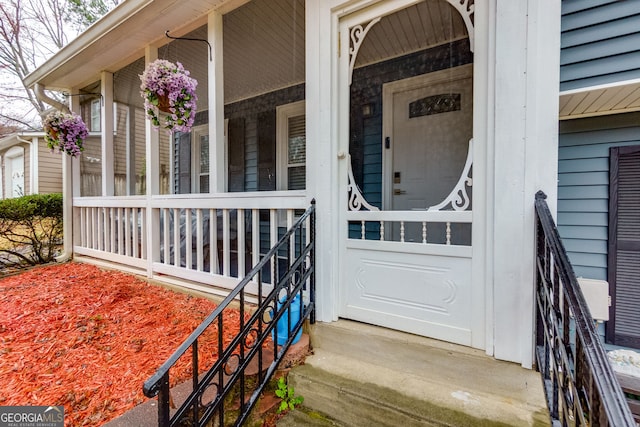 entrance to property featuring a porch