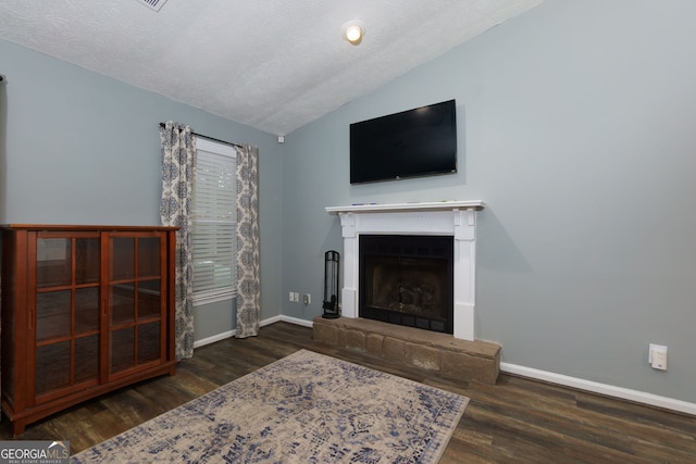 living room with baseboards, wood finished floors, and vaulted ceiling