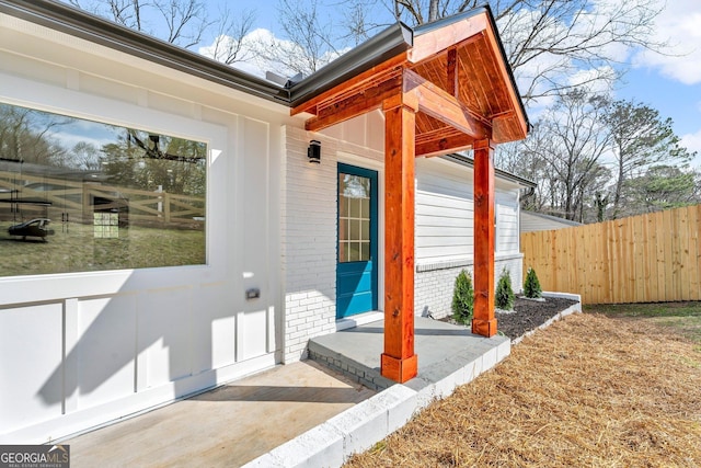 926 Natham Dr SE, Atlanta, GA 30315 - view of exterior entry featuring fence and brick siding