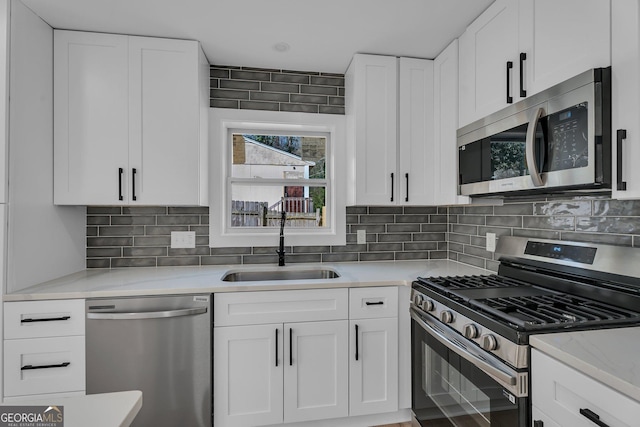 926 Natham Dr SE, Atlanta, GA 30315 - kitchen featuring white cabinetry, a sink, stainless steel appliances, and tasteful backsplash