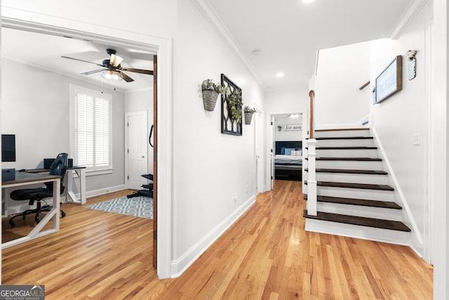 hallway with stairs, baseboards, light wood-type flooring, and ornamental molding