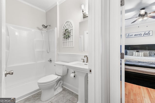 ensuite bathroom with ensuite bath, a sink, a shower, crown molding, and toilet