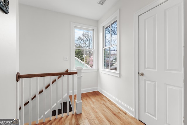 interior space with visible vents, baseboards, and wood finished floors