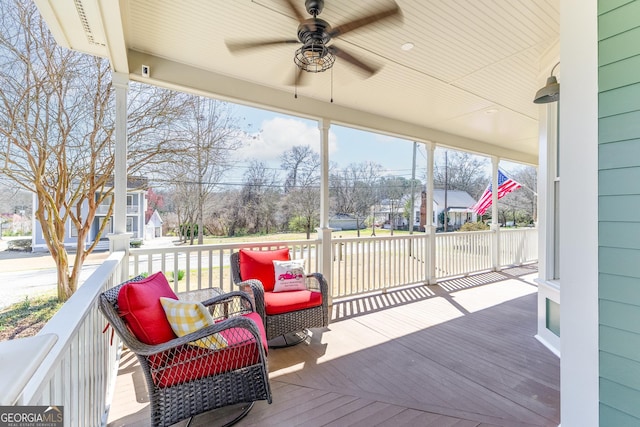 deck featuring a residential view and ceiling fan