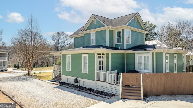 view of front of house with covered porch and a shingled roof