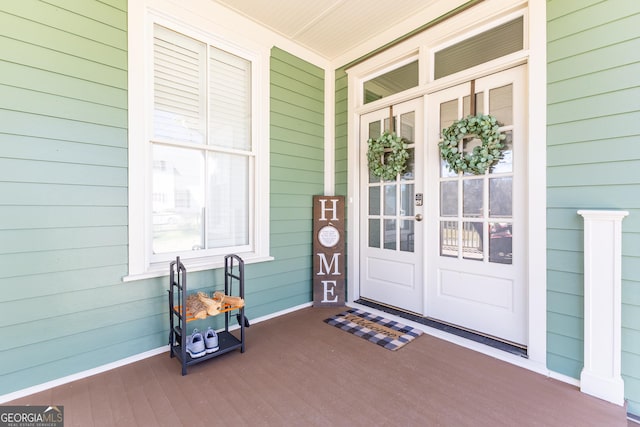 view of exterior entry with covered porch