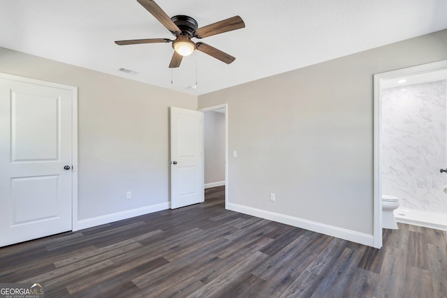 unfurnished bedroom with visible vents, connected bathroom, dark wood-type flooring, and baseboards