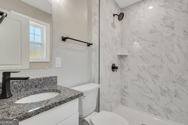 full bathroom featuring vanity, a shower stall, and toilet