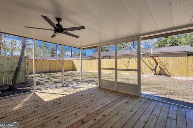 unfurnished sunroom with a wealth of natural light and a ceiling fan