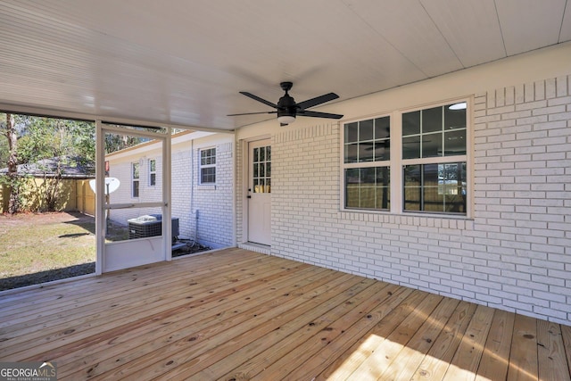 wooden terrace with ceiling fan and fence