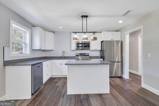 kitchen featuring visible vents, appliances with stainless steel finishes, and white cabinets