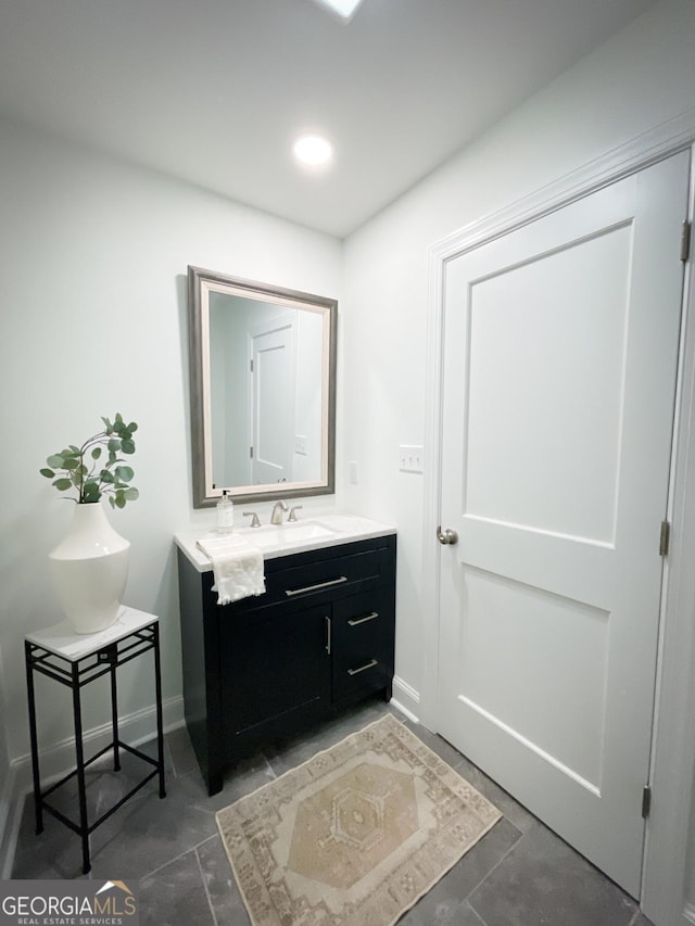 bathroom featuring recessed lighting, baseboards, and vanity