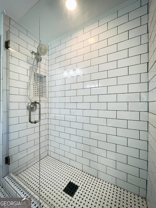 full bathroom featuring a shower stall and crown molding