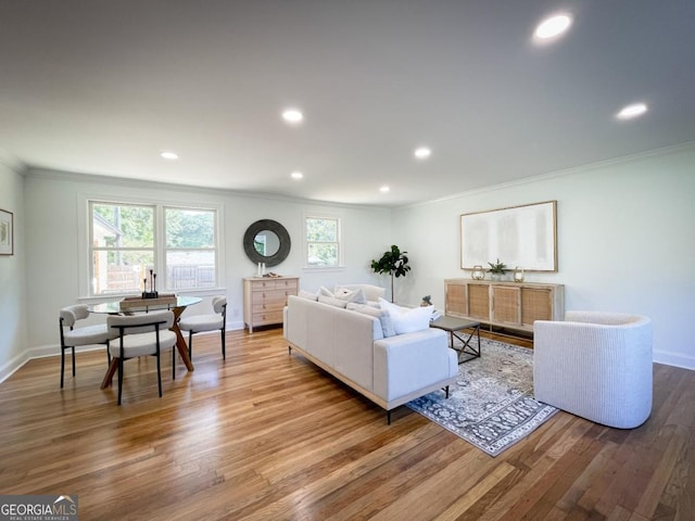 living room featuring recessed lighting, ornamental molding, baseboards, and wood finished floors