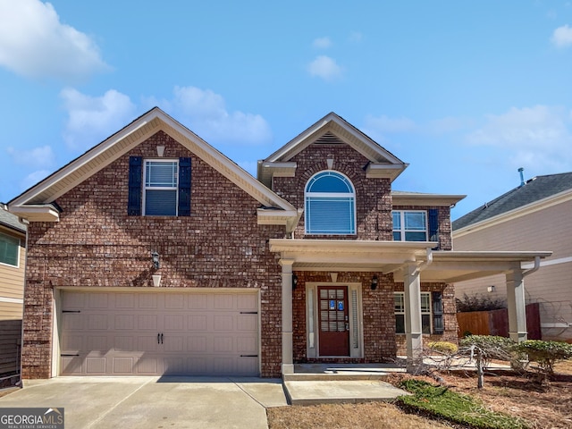 traditional home featuring brick siding and concrete driveway