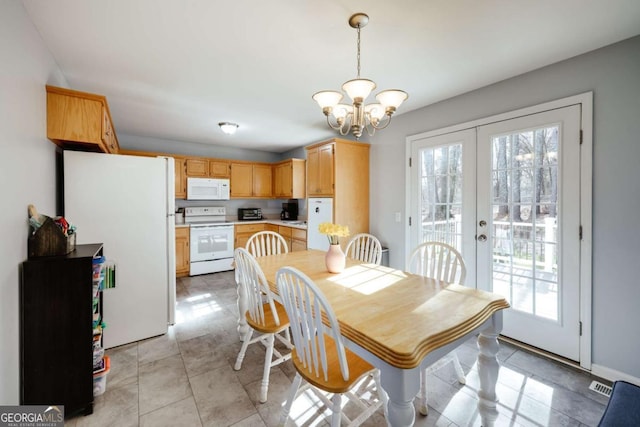 dining area featuring a wealth of natural light, french doors, visible vents, and an inviting chandelier