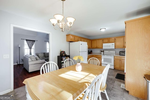 dining space featuring baseboards and a chandelier