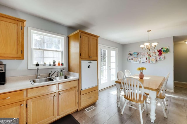 kitchen with visible vents, french doors, light countertops, and a sink