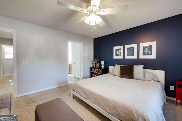 bedroom featuring ensuite bath, baseboards, carpet floors, and ceiling fan