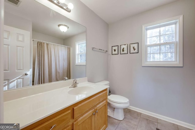 bathroom featuring vanity, baseboards, visible vents, tile patterned flooring, and toilet