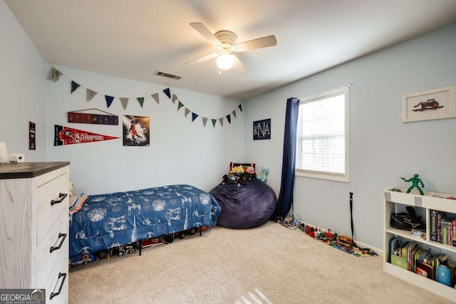 carpeted bedroom with a ceiling fan and visible vents