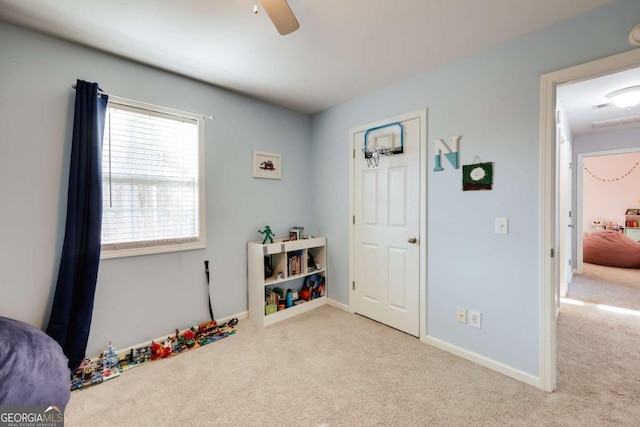 playroom with baseboards, ceiling fan, and carpet flooring