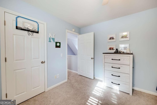 unfurnished bedroom with baseboards, carpet floors, and a ceiling fan